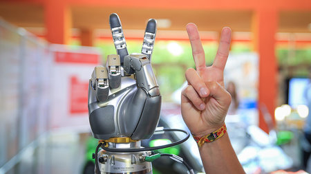 Two hands make the victory gesture.